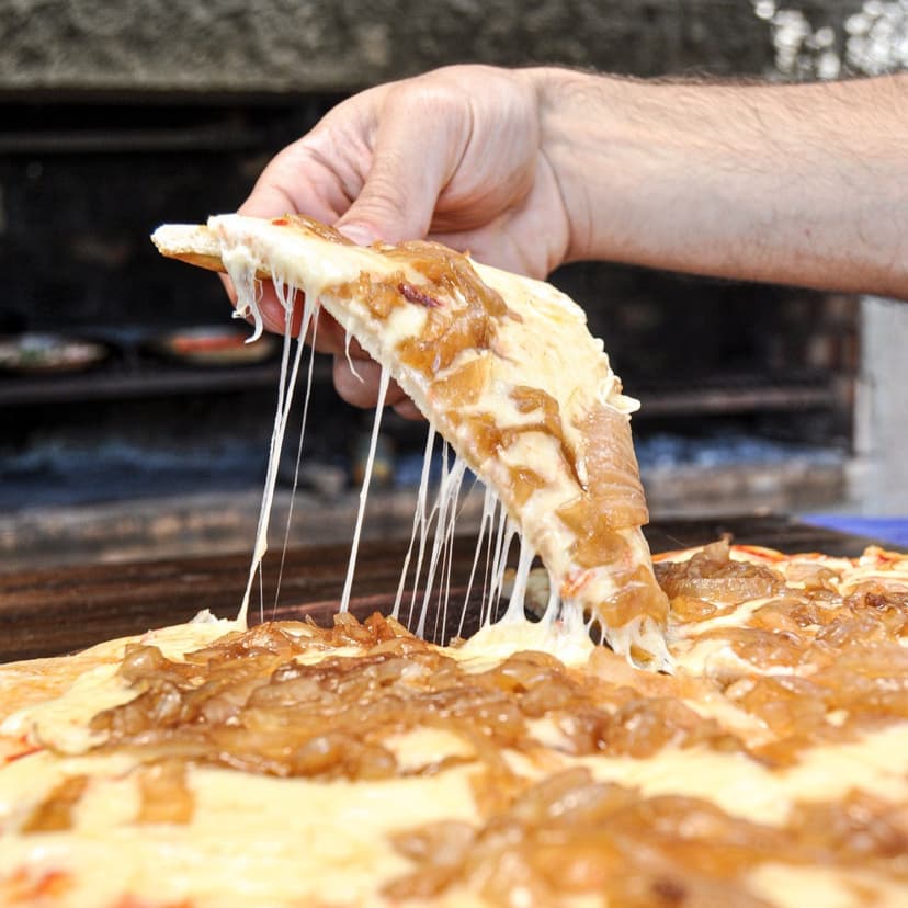 Porción de pizza con mucho queso